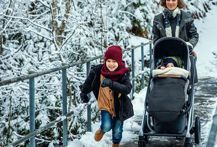 Family enjoying a winter walk with a stroller