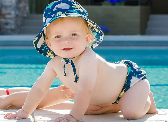 A baby wearing a hat and a swim diaper