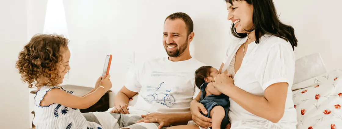 Man in white crew neck t-shirt sitting beside woman in white crew t-shirt