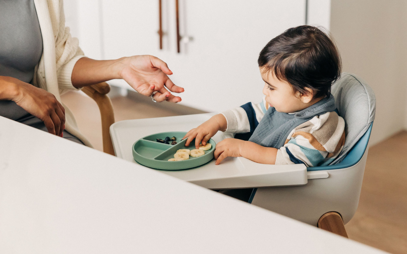 Baby enjoying a meal in a high chair