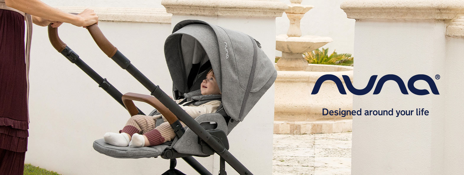 Nuna stroller in a sunlit courtyard